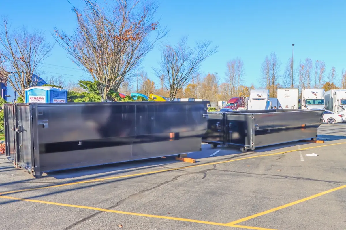 Professional dumpster rental service with roll-off container on residential driveway in Longmont